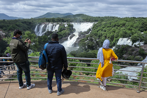 Tourists gazing at the mesmerizing 'Barachukki' waterfall during monsoon which was re-opened recently after the Covid 19 pandemic lock down in Shivanasamudra, India.