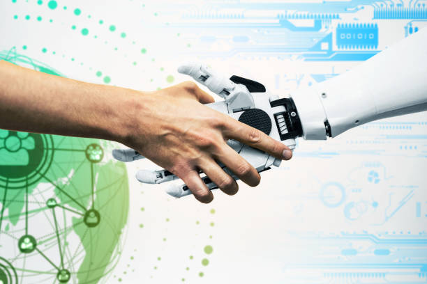 istock a man shakes hands with a robot close-up. engineer to create a robot. future robotics concept 1332659551