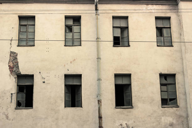 istock Broken windows of an old building 1332664679