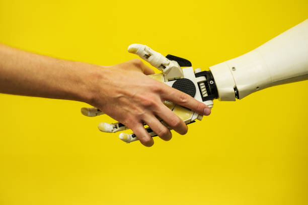 istock a man shakes hands with a robot close-up. engineer to create a robot. future robotics concept 1332665675