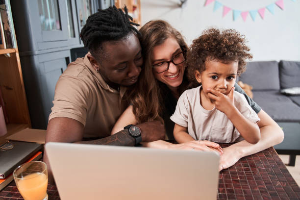 istock Girl feeling shocked while watching something at the laptop with her diverse parents 1332666968