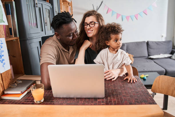 istock Diverse spouses enjoying of watching movie while their daughter spending time with them 1332666974