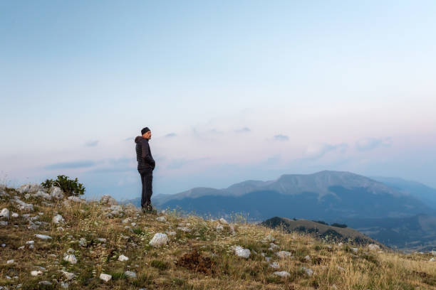 istock Hiker meditates amidst the mountain landscape. 1332667347