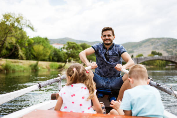 istock Young family enjoying boat ride 1332669846