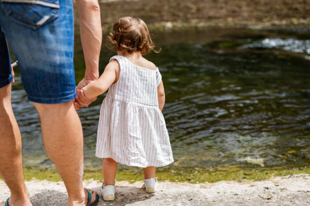 istock Father and daughter exploring nature 1332670348