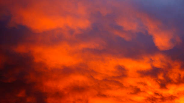 istock Sunset dramatic sky with bright orange and dark red stormy clouds. Nature background 1332671087