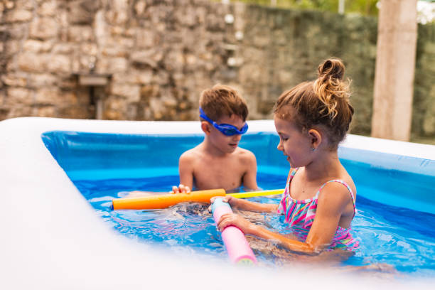 istock Children games in swimming pool 1332671428