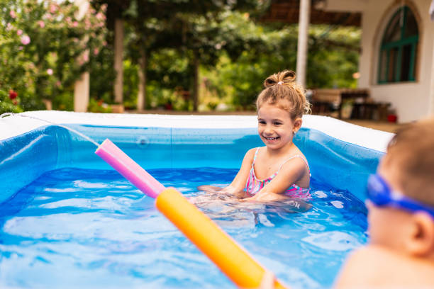 istock Children games in swimming pool 1332671766