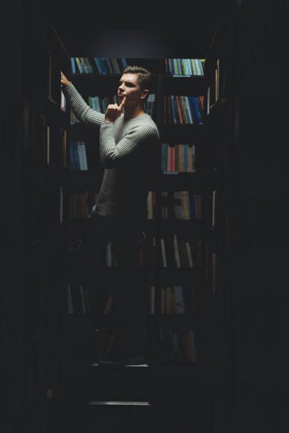 istock Student in the library searches for literature 1332672559