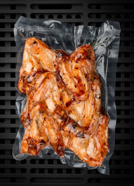 istock Vacuum-packed grilled meat, on a dark background, chicken wings. Ready to eat. 1332678377