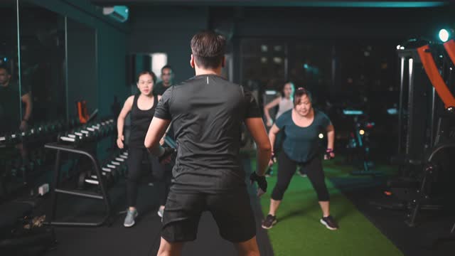 asian chinese body positive woman attending fitness sport training class in gym health club