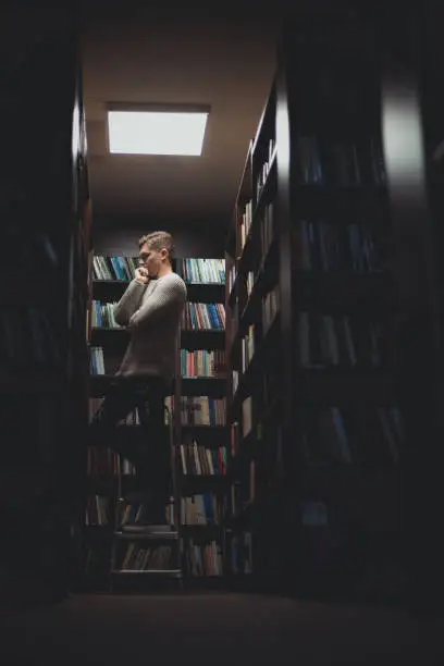 Photo of Student in the library searches for literature