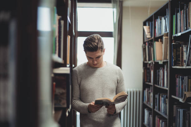 istock Student in the library searches for literature 1332686502