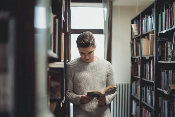 Photo of Student in the library searches for literature