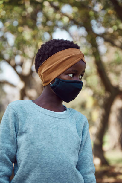 istock Young black South African girl with mask 1332687965
