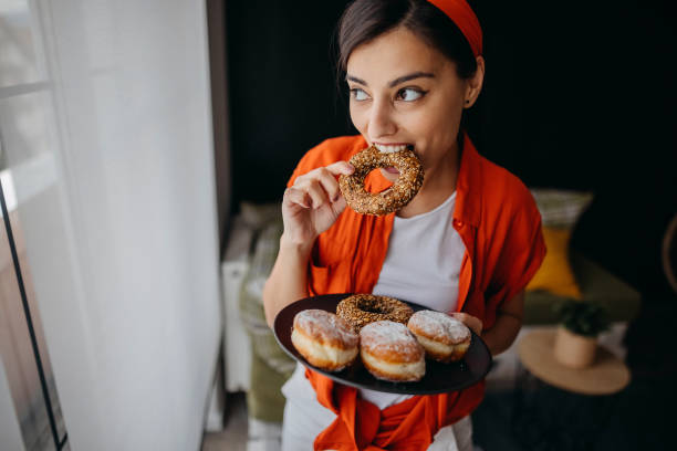 Young woman eating donuts