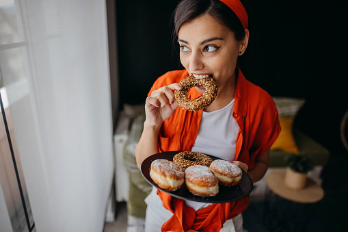 Young woman eating donuts