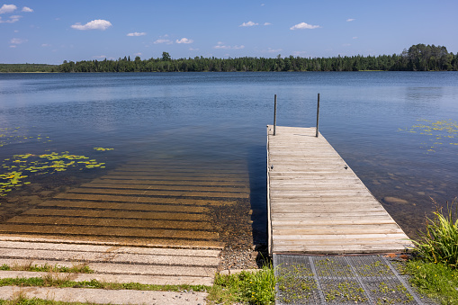 A scenic lake with a boat dock and ramp.