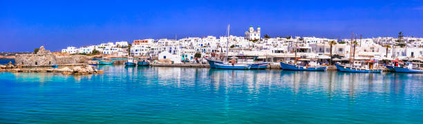 Greece travel. Cyclades, Paros island. Charming fishing village Naousa. view of old port with  boats and street taverns by the sea. Greece travel. Cyclades, Paros island. Charming fishing village Naousa. view of old port with  boats and street taverns by the sea. paros stock pictures, royalty-free photos & images
