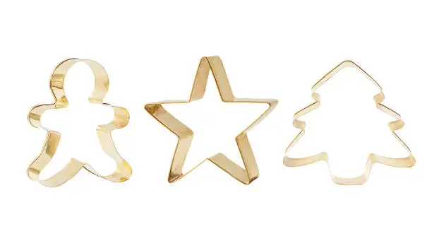 Gingerbread man, star and Christmas tree metallic cookie cutters isolated on white background