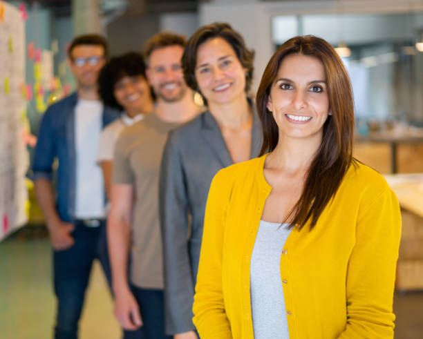 istock Happy group of creative people smiling at the office 1332694017