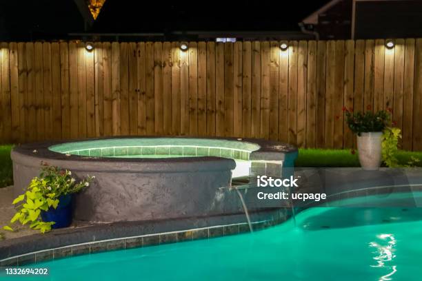A Backyard Swimming Pool And Hot Tub Hot Tob At Night Stock Photo - Download Image Now