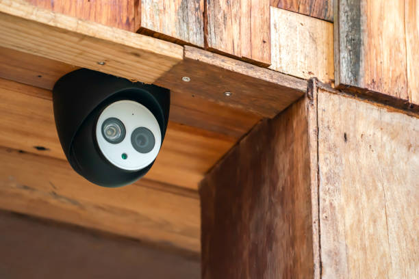 istock close up mini CCTV camera black case is set up on the wood ceiling building. 1332698102