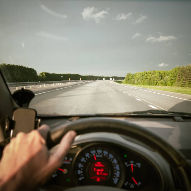 istock driving a car. summer road travel. 1332698594