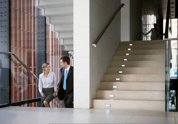 istock Business people ascending steps in office 1332700176