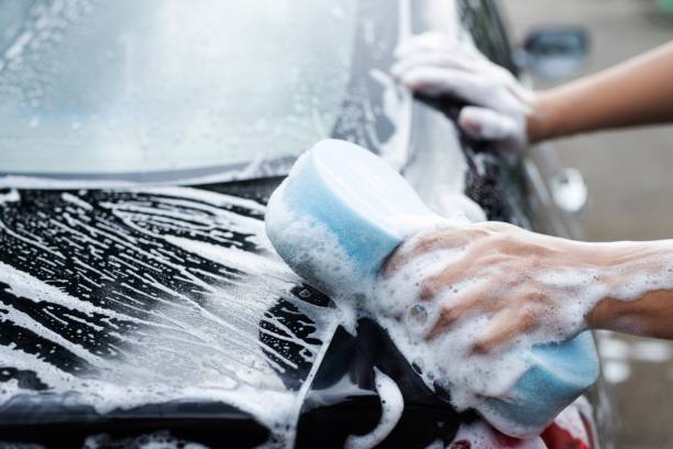 istock He was washing a black car with a blue sponge. 1332700975