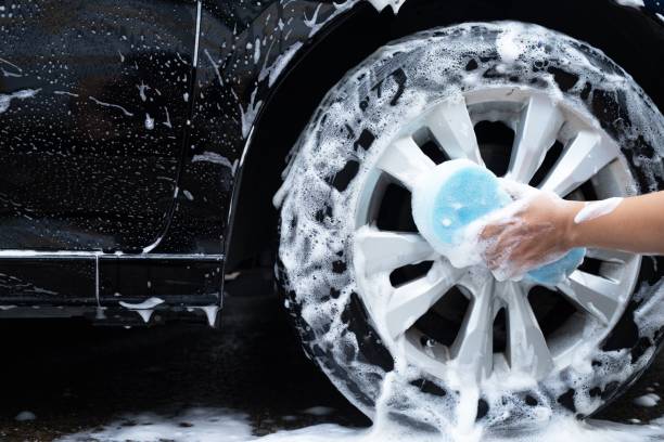 istock man washing his car wheels with blue sponge 1332700982
