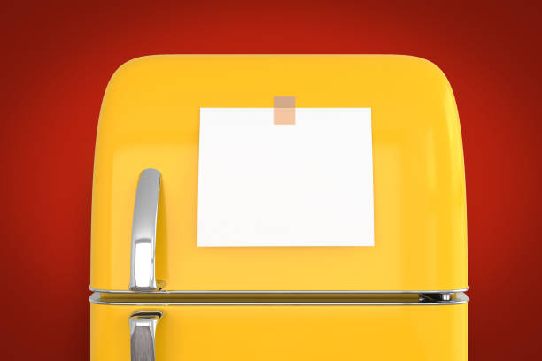 istock blank memo note sticker on yellow refrigerator close up. blank paper reminder on retro fridge door close up mockup on red wall 1332701601