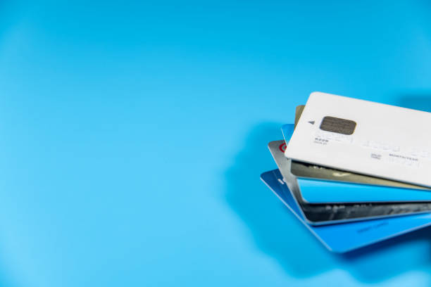 istock Credit cards stacked on a blue background 1332701604