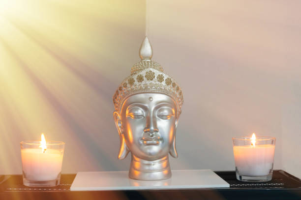 istock Buddhist altar with silver buddha head and lighted candles 1332702753
