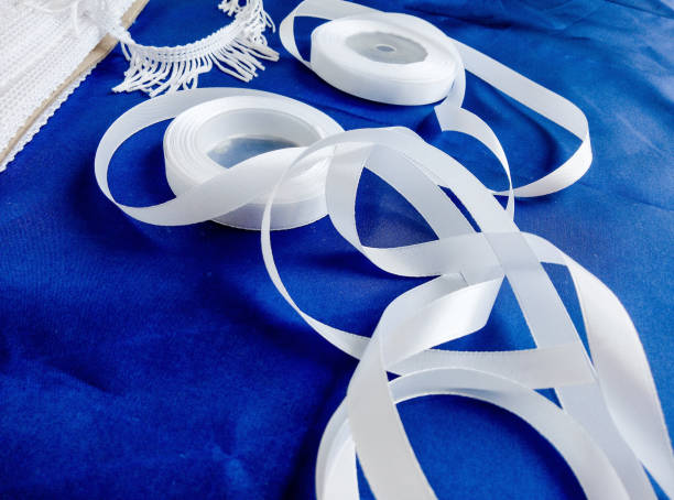 istock roll of white ribbon and tassel 1332703292