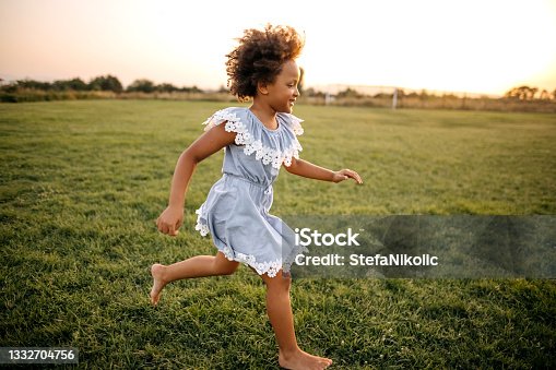 istock Kid running on sports field 1332704756