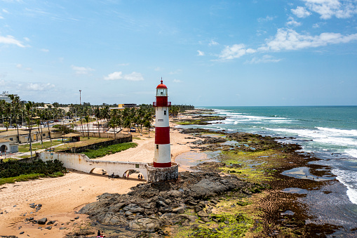 The Itapuã lighthouse or Ponta de Itapuã lighthouse is a lighthouse in Salvador, Bahia, Brazil. It is located on Itapuã beach, in the Itapuã sub-district, about 23 kilometers (14 mi) east-northeast of the Barra lighthouse.\n\nIt is a 21 meter (69 foot) conical cast iron tower, set on a concrete base and connected to the beach by a concrete bridge. The lighthouse is painted with white and red horizontal bars.\n\nIt emits white lightning every six seconds, with a range of 15 nautical miles (28 km).[2]