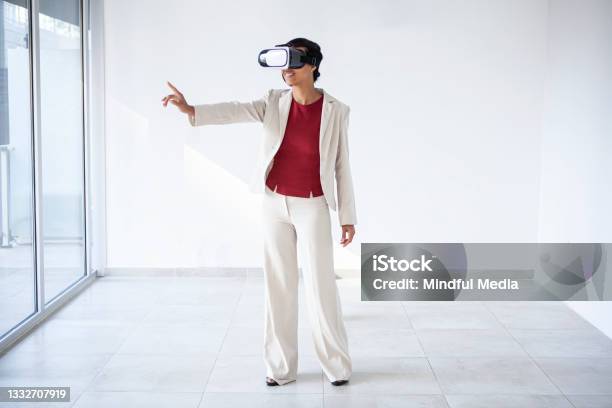 Latin Woman In A Formalwear Using Virtual Reality Glasses Stock Photo - Download Image Now