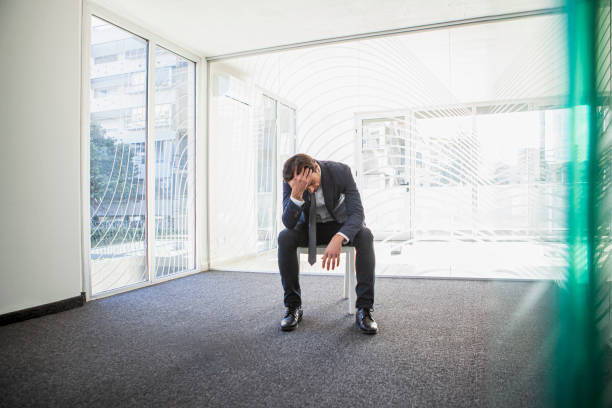 istock Stressed latin businessman holding his head while sitting on chair 1332708187
