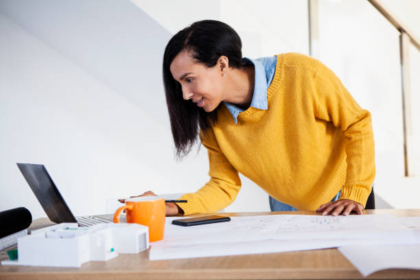 istock Young adult latin architect using laptop 1332708212