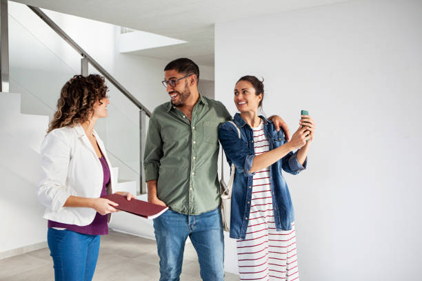 istock Young latin couple talking with real estate agent 1332708446