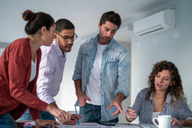 istock Multi ethnic group of architects and designers working on project together 1332708514