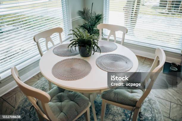 Close Up Of A Small Table And Four Chairs In An Eat In Kitchen With A Tile Floor Stock Photo - Download Image Now