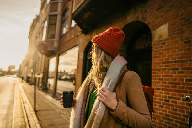istock Young smiling woman on a city break 1332710131