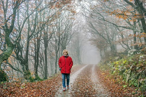 Happy Senior Woman Hiking in the autumn forest, Primorska, Julian Alps, Slovenia