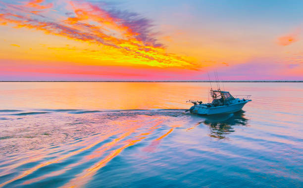 Speedboat with fishers at the river at sunset