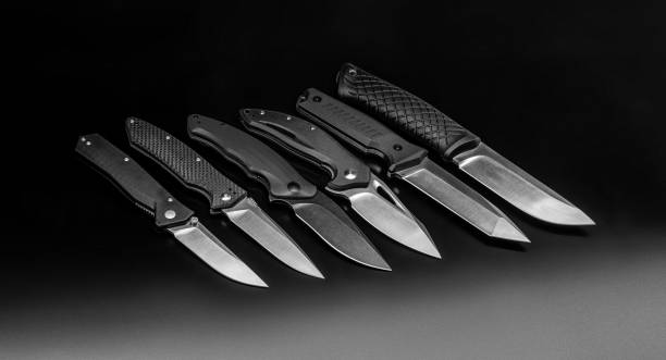 istock folding knives on a black background. pen knives on a dark background 1332714844