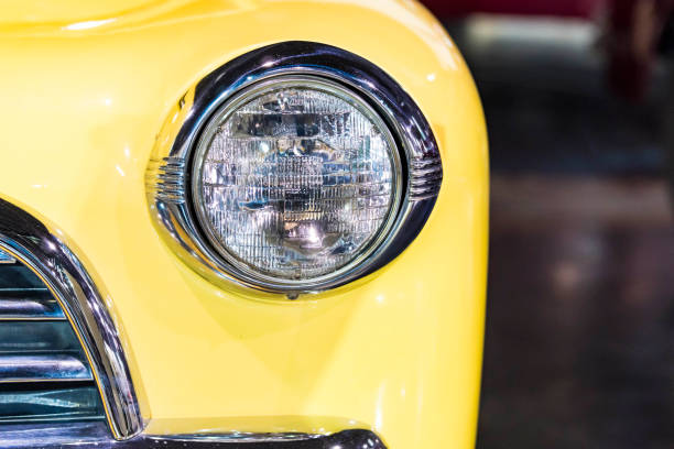 istock Classic Yellow Retro looking Car Headlight with copy space and blurred background 1332715305