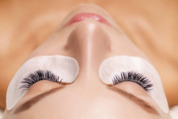 istock Eyelash Extension Procedure. Woman Eye with Long Eyelashes. Close up, selective focus 1332715577