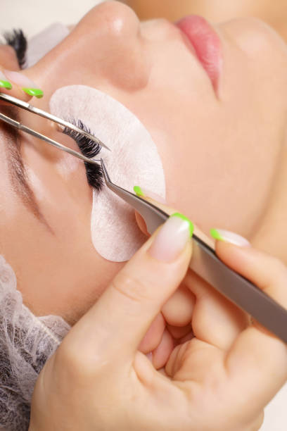 istock Eyelash Extension Procedure. Woman Eye with Long Eyelashes. Close up, selective focus 1332716294